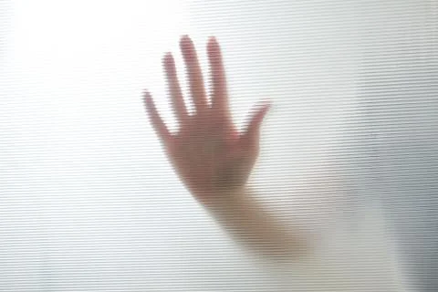 Diffused silhouette of female hands through plastic Stock-Fotos