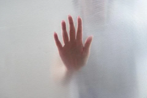 Diffused silhouette of female hands through plastic Stock-Fotos