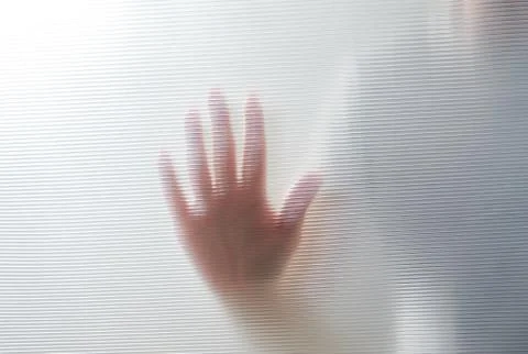 Diffused silhouette of female hands through plastic Foto stock