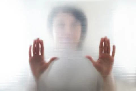 Diffused silhouette of female hands, view with shadow through plastic Stock-Fotos
