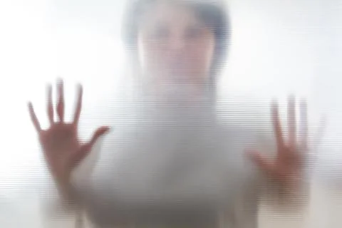 Diffused silhouette of female hands, view with shadow through plastic Stock-Fotos
