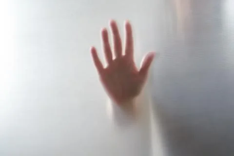 Diffused silhouette of female hands, view with shadow through plastic Stock-Fotos