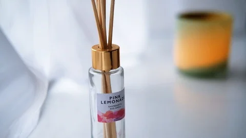Diffuser bottle with sticks in a pure white environment with a green Stock Footage 113742485