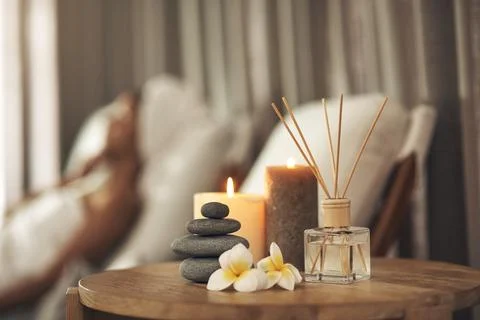 Diffuser, candles or pile of rocks in spa, aromatherapy treatment or soothing Stock Photos