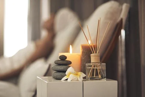 Diffuser, candles or stack of rocks in spa, aromatherapy treatment or soothing Stock Photos