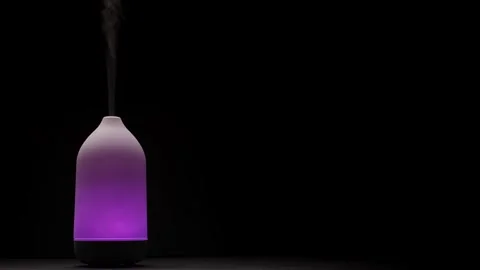 Diffuser diffusing steam on black background Stock Footage 262274119