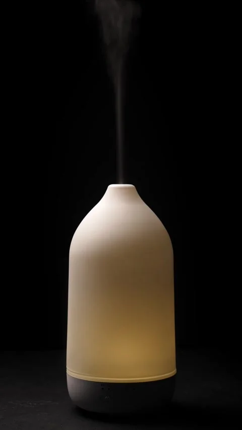 Diffuser diffusing steam on black background. Closeup. Vertical Stock Footage 327121668
