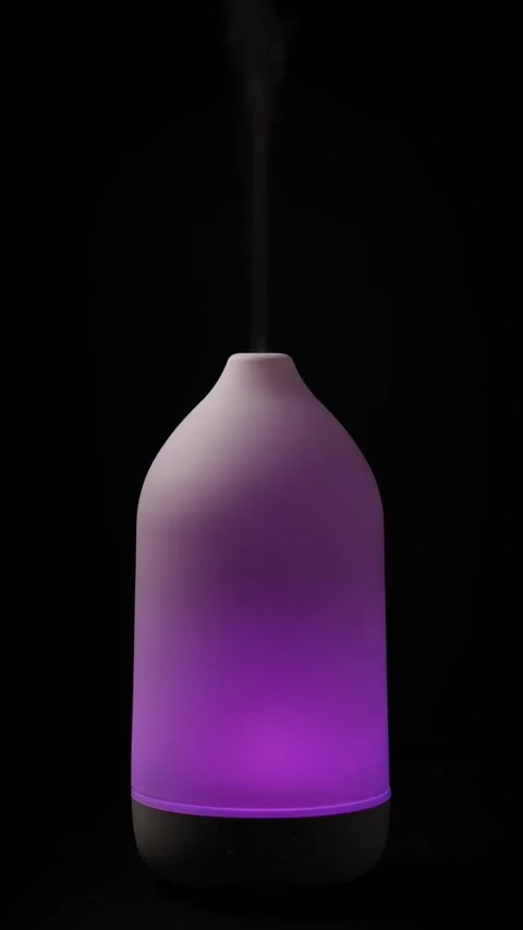 Diffuser diffusing steam on black background. Closeup. Vertical Stock Footage 327121711