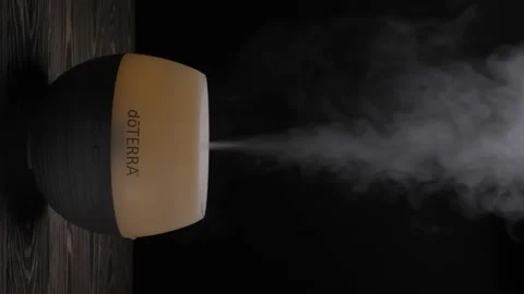 Diffuser Doterra for essential oils diffusing steam on black. Vertical video Stock Footage 208825470