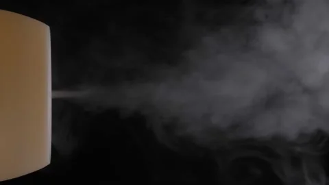 Diffuser for essential oils diffusing steam on black background Stock Footage 198930913