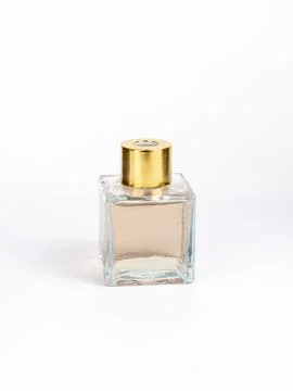 Diffuser for home. Bottle with brown transparent liquid on white background Stock Photos