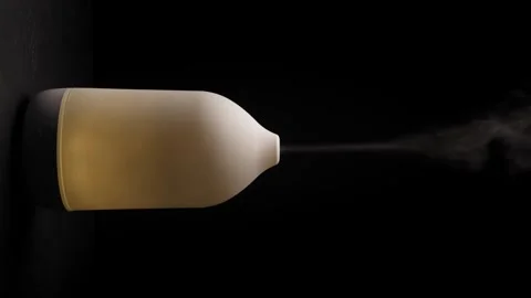Diffuser with white light diffusing steam on black background. . Vertical Video stock 241346825