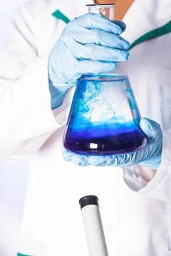 Diffusion Scientist shows a diffusion in the flask ,model released, Symbol... Stock Photos