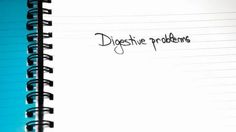 Digestive problems handwriting  text on paper, on office agenda. Copy space. Stock Photos