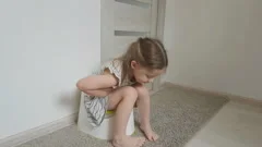 a little girl sitting on the toilet, the, Stock Video