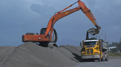 Digger and  truck loading shingle  Stock Footage 44025560
