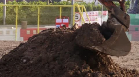 Digger dumping soil in a truck Stock Footage 21977931