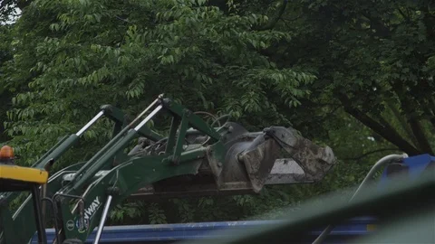 Digger excavating and dumping earth, close up Stock Footage 93207635