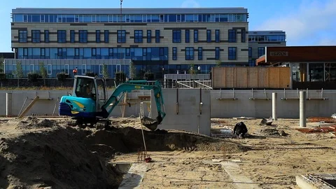 Digger Loading Ground and Levelling Sand in an Office Building Site Stock Footage 95906474