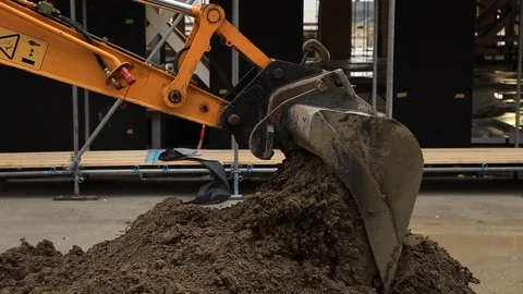 Digger Loading Ground and Pouring Ground on an Office Building Site Stock Footage 95847566