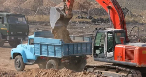 Digger loading truck with soil (4K) Stock Footage 166842948