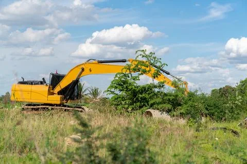 Digger machine digging and adjusting ground level. Stock Photos