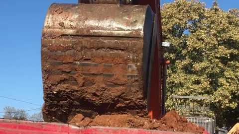 Digger or excavator removing rubble from demolition site. Hand held. Video stock 252343948