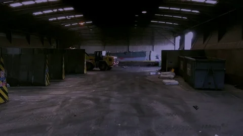 Digger piling in garbage into truck at large rubbish collection and recycling Video stock 76556133