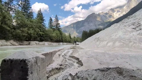 Digger shovelling sand from the river in Chamonix into a pile Video stock 342448723