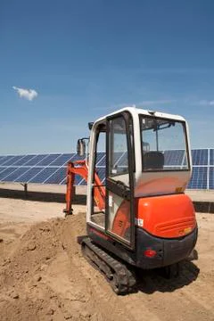 Digger on solar panel construction site Stock Photos
