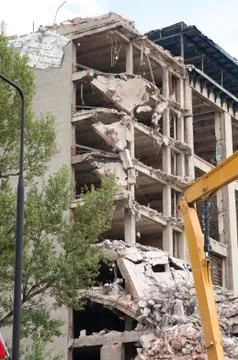 Digger working during the demolition of the building Stock Photos