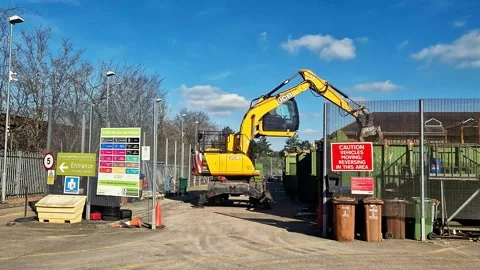 Digger working in waste recycling site taken on 2nd March 2025 in Hertfordshire Stock Footage 303358313