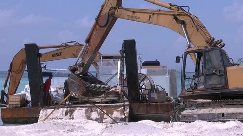 Diggers on the beach building a resort in a tropical island Stock Footage 125536642