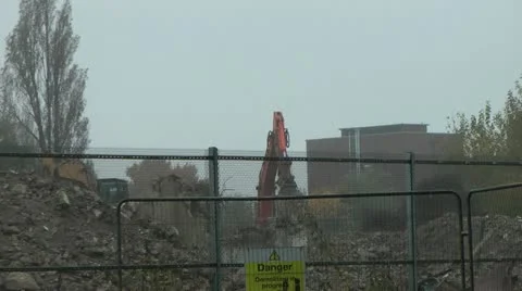 Diggers clearing rubble as old tower block is demolished Stock Footage 14770206