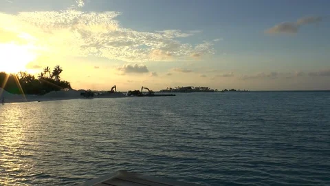 Diggers machine working in a tropical island to build a resort Stock Footage 125552906