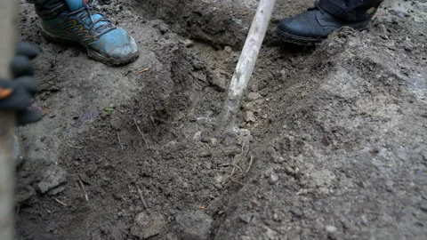 Digging and shoveling foundation at construction site Stock Footage 158980666