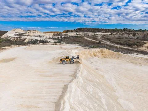 Digging and transporting materials in a quarry during daylight hours with c.. Stock Photos