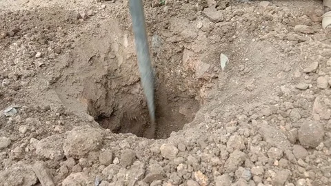 Digging a hole in the ground using a crowbar Stock Footage 287094299