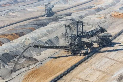 Digging machine busy with deposit soil in Hambach mine Germany Stock Photos
