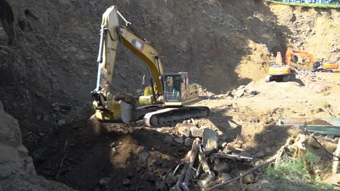 Digging machine for digging and dumping soil. The excavator is working. mining Video stock 155901222