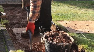 Digging out before building garden steps Stock Footage 85512922
