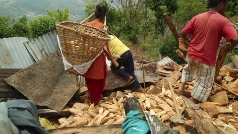 Digging out rubble of a collapsed home following earthquake emergency in Nepal Stock Footage 171240478