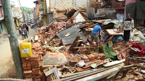 Digging out rubble of a collapsed home following earthquake emergency in Nepal Stock Footage 171241376