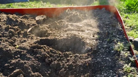 Digging soil in garden bed with shovel on sunny day close-up in slow motion Stock Footage 337544553