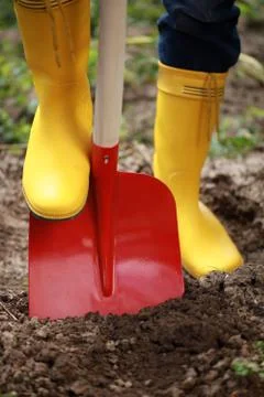 Digging soil with a shovel Stock Photos