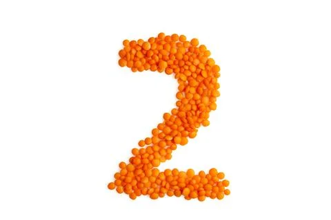 The digit '2' (two) formed from red lentil grains Stock Photos