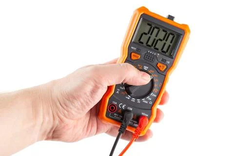 Digit 2020 on lcd screen of digital electrical multimeter in left hand, iso.. Stock Photos