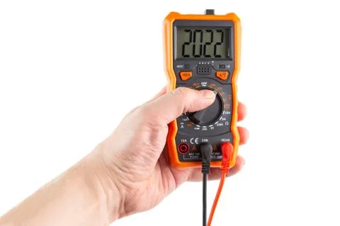 Digit 2022 on lcd screen of digital electrical multimeter in left hand, isola Photos