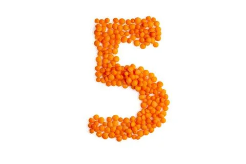 The digit '5' (five) formed from red lentil grains Stock Photos