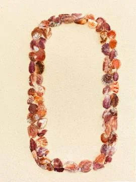 Digit zero made of seashells on a coral sandy beach 스톡 사진